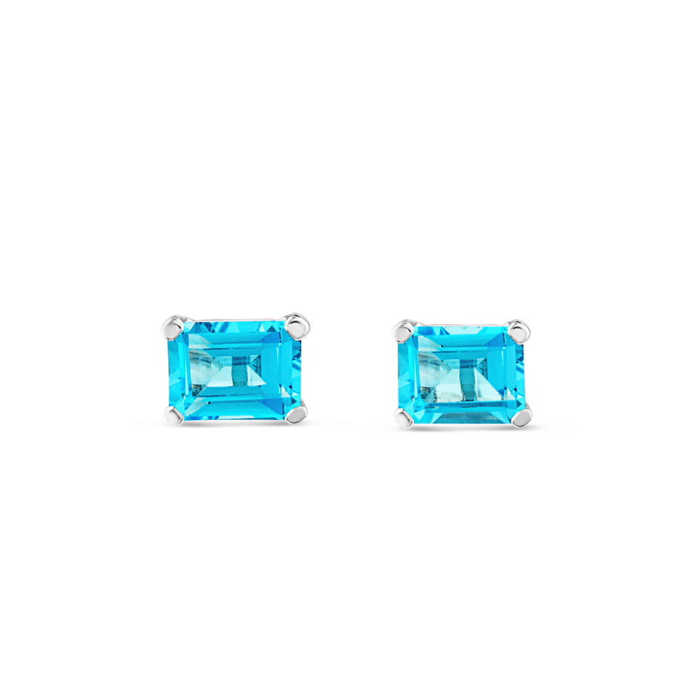 Pendientes de oro blanco con topacio azul en 4 garras talla esmeralda