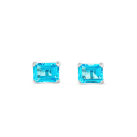 Pendientes de oro blanco con topacio azul en 4 garras talla esmeralda