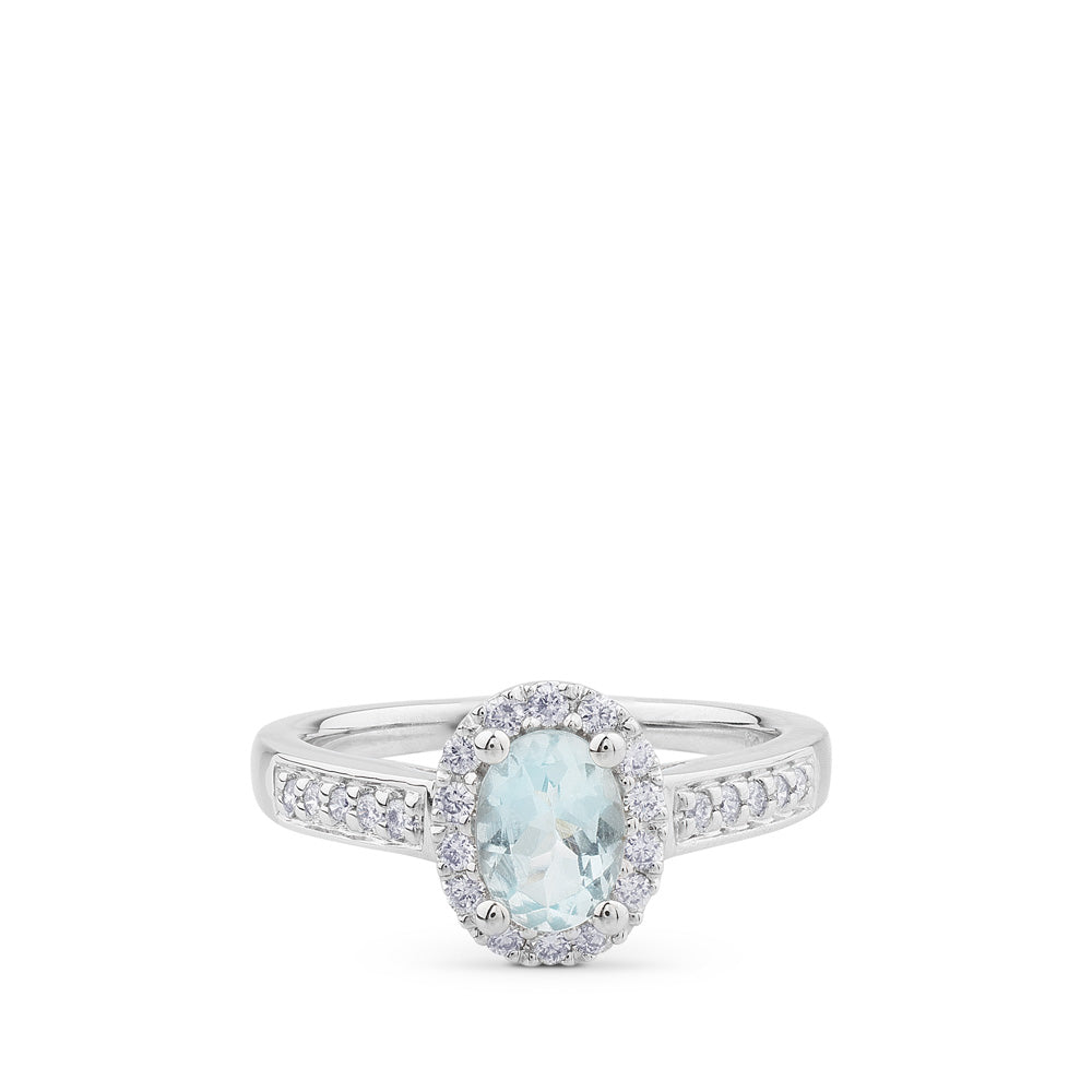 Sortija de oro blanco y diamantes con aguamarina y orla de pavé de diamantes