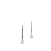 Pendientes de oro blanco con hilera de diamantes y diamante al aire