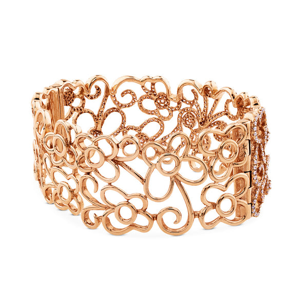 Pulsera ancha rígida de oro rosa y diamantes talla brillante.