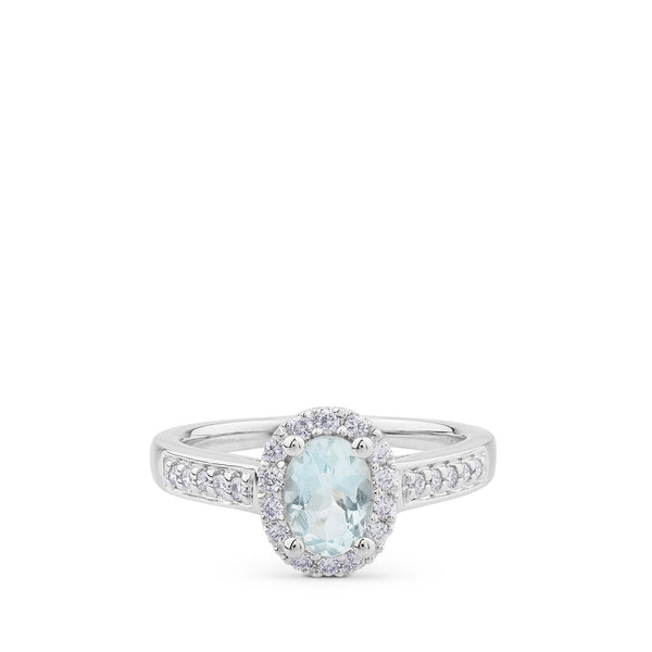Sortija de oro blanco y diamantes con aguamarina y orla de pavé de diamantes