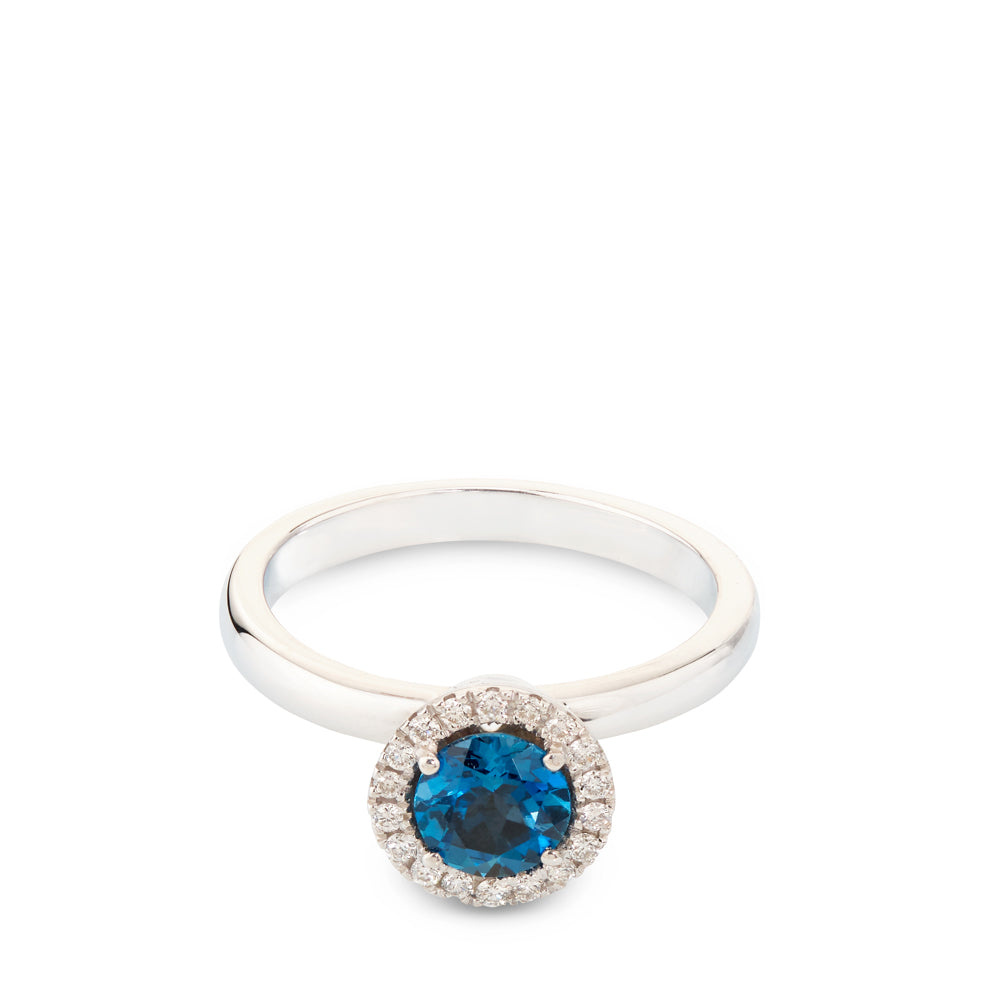 Sortija de oro blanco con diamantes y topacio azul en altura