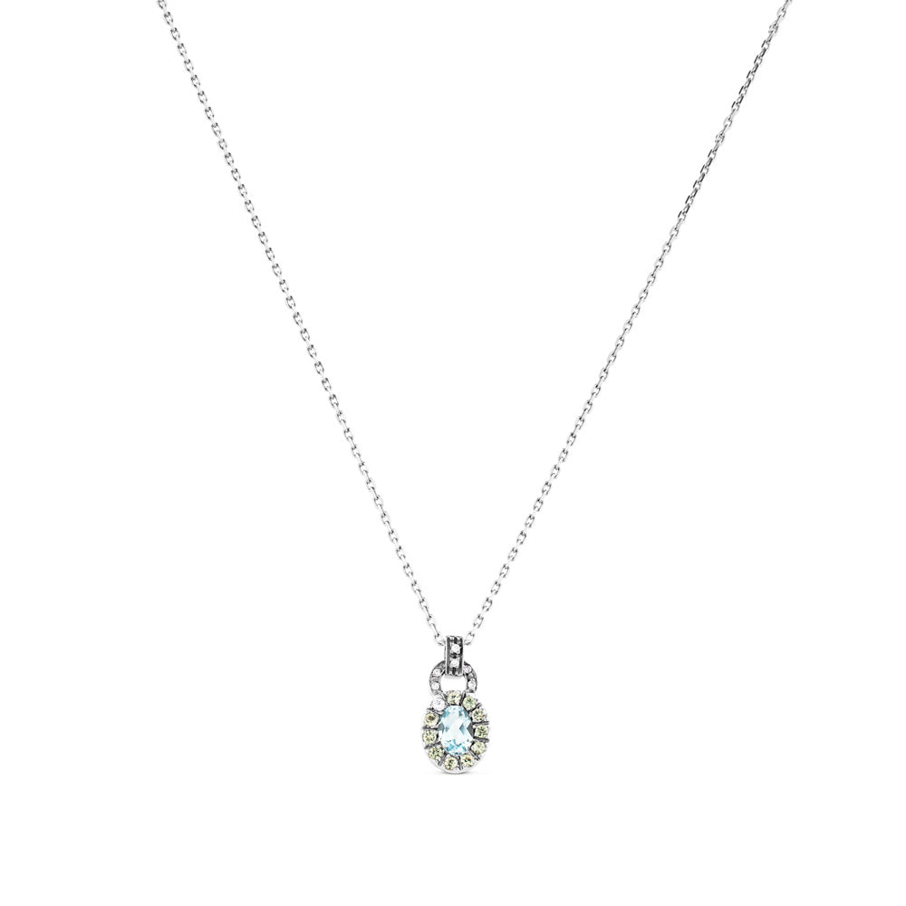Colgante de oro blanco con diamantes y topacio azul con orla de pavé de diamantes