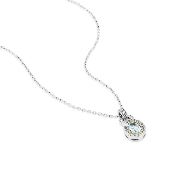 Colgante de oro blanco con diamantes y topacio azul con orla de pavé de diamantes