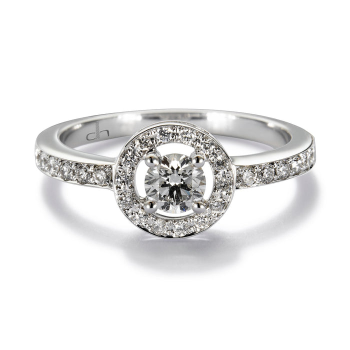 Solitario "María Valentina" de oro blanco con diamante central en 4 garras, orla y montura de diamantes